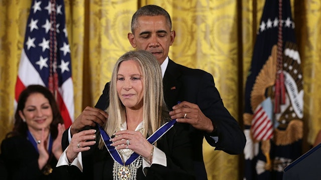 WASHINGTON, DC - NOVEMBER 24: U.S. President Barack Obama (R) presents the Presidential Medal of Freedom to singer Barbra Streisand (L) during an East Room ceremony November 24, 2015 at the White House in Washington, DC. Seventeen recipients were awarded with the nationÕs highest civilian honor. (Photo by