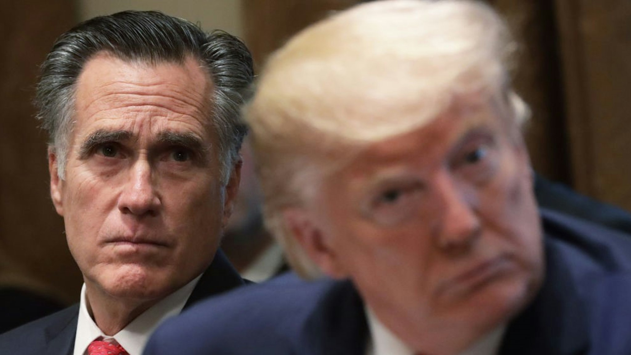 WASHINGTON, DC - NOVEMBER 22: U.S. Sen. Mitt Romney (R-UT) and President Donald Trump listen during a listening session on youth vaping of electronic cigarette on November 22, 2019 in the Cabinet Room of the White House in Washington, DC. President Trump met with business and concern group leaders to discuss on how to regulate vaping products and keep youth away from them. (Photo by