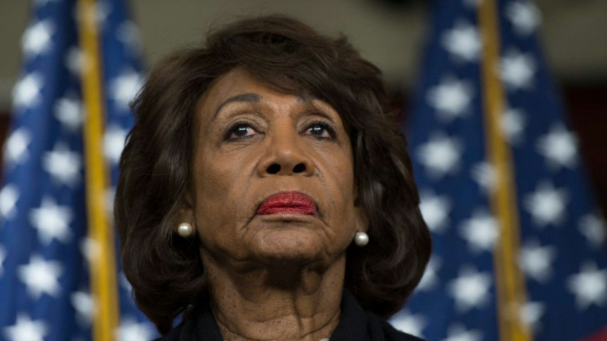 US Representative Maxine Waters (D-CA) looks on before speaking to reports regarding the Russia investigation on Capitol Hill in Washington, DC on January 9, 2018