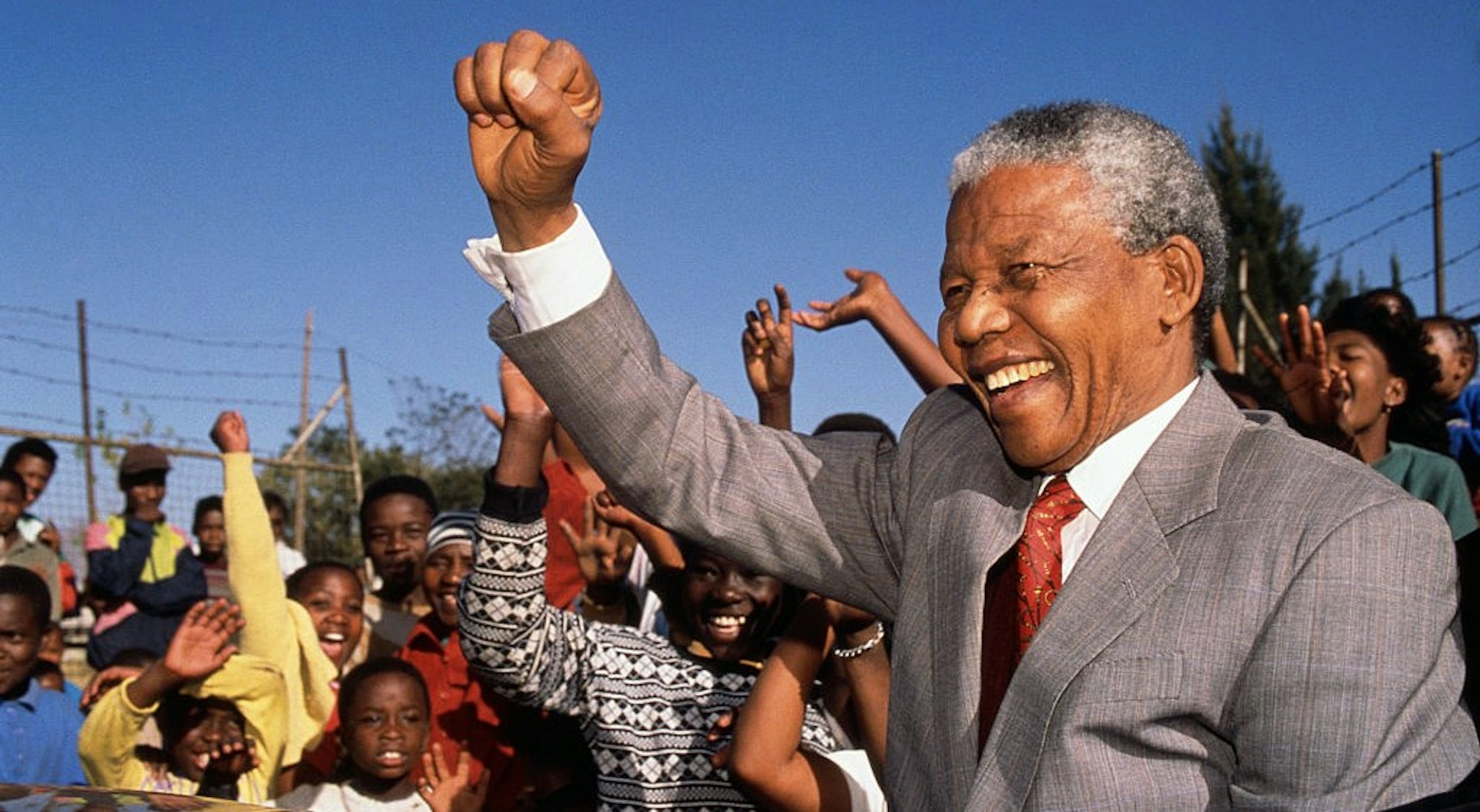 (Original Caption) Johannesburg, South Africa: Nelson Mandela visits Hlengiwe School to encourage students to learn - Former President of South Africa and longtime political prisoner, held by the Apartheid based government from 1964-1990 for sabotage. With the coming of a freer political climate, Mandela was released from his life sentence at Victor Vester Prison on February 11, of 1990. He went on to lead the African National Congress in negotiations with President F.W. de Klerk, that resulted in the end of Apartheid and full citizenship for all South Africans. He and de Klerk received a joint Nobel Peace Prize in 1993 for their efforts. Mandela was elected president in 1994. (Photo by ©