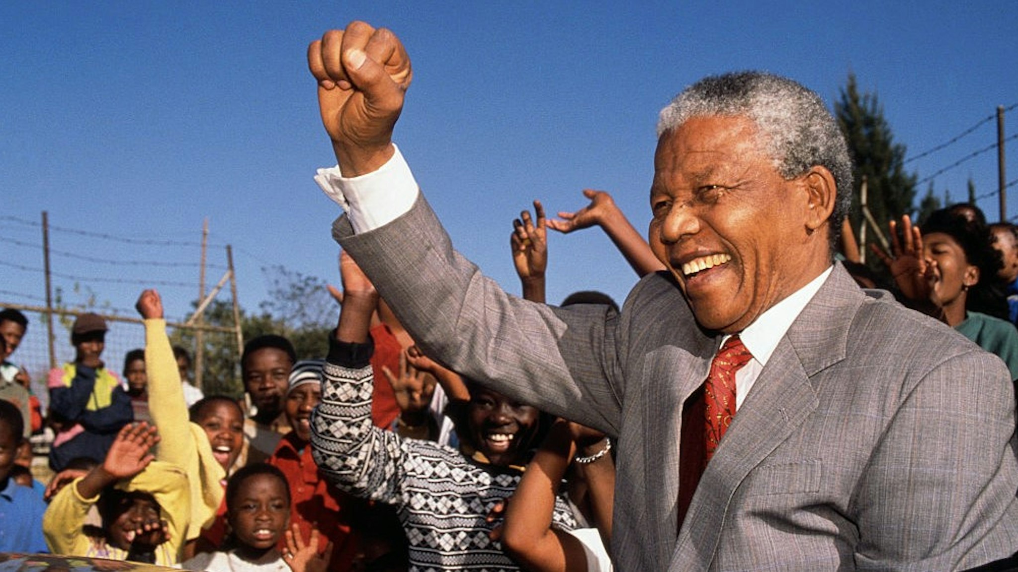 (Original Caption) Johannesburg, South Africa: Nelson Mandela visits Hlengiwe School to encourage students to learn - Former President of South Africa and longtime political prisoner, held by the Apartheid based government from 1964-1990 for sabotage. With the coming of a freer political climate, Mandela was released from his life sentence at Victor Vester Prison on February 11, of 1990. He went on to lead the African National Congress in negotiations with President F.W. de Klerk, that resulted in the end of Apartheid and full citizenship for all South Africans. He and de Klerk received a joint Nobel Peace Prize in 1993 for their efforts. Mandela was elected president in 1994. (Photo by ©