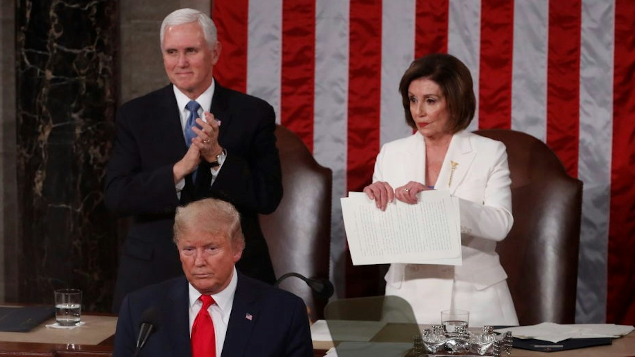 Speaker of the House Nancy Pelosi, a Democrat from California, right, prepares to rip up papers after U.S. President Donald Trump, bottom left, delivers a State of the Union address to a joint session of Congress at the U.S. Capitol in Washington, D.C., U.S., on Tuesday, Feb. 4, 2020. President Donald Trump will try to move past his impeachment and make a case for his re-election in Tuesday's State of the Union address by taking credit for a strong economy, newly signed trade deals and an immigration crackdown. Photographer: