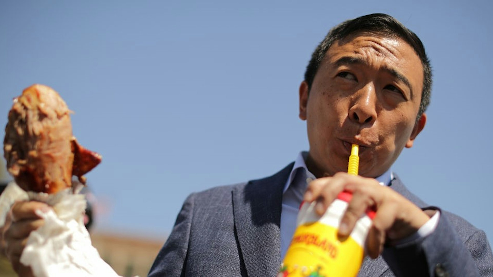 DES MOINES, IOWA - AUGUST 09: Democratic presidential candidate Andrew Yang eats a roasted turkey leg while visiting the Iowa State Fair August 09, 2019 in Des Moines, Iowa. Twenty two of the 23 politicians seeking the Democratic Party presidential nomination will be visiting the fair this week, six months ahead of the all-important Iowa caucuses. (Photo by