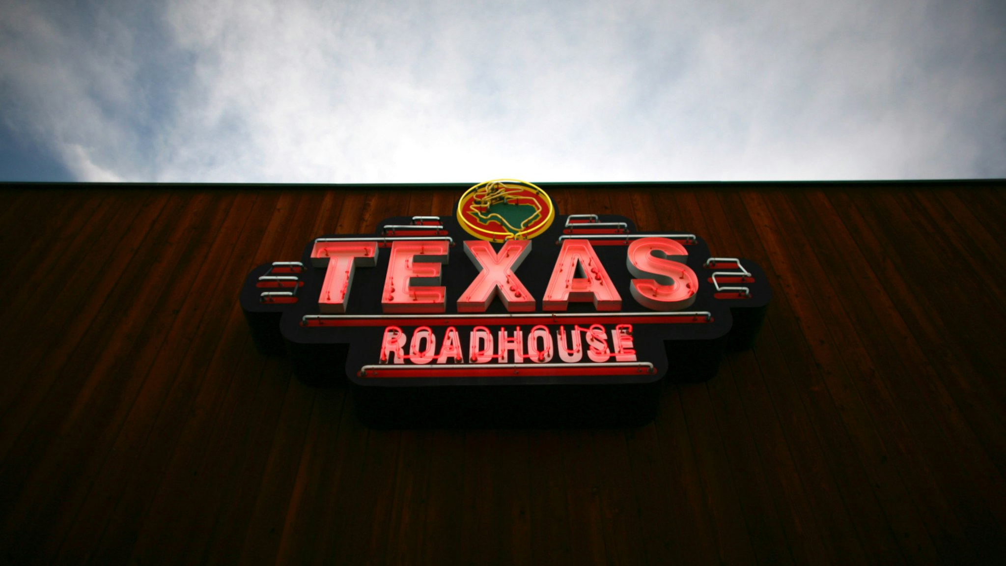 Texas Roadhouse Inc. signage is displayed outside of a restaurant in Arvada, Colorado, U.S., on Friday, March 11, 2011.