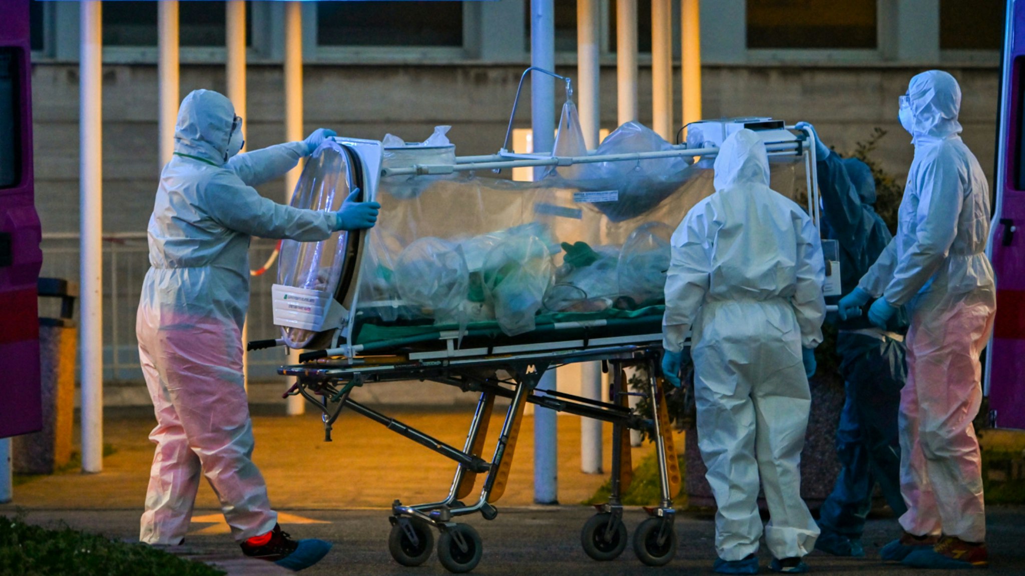Medical workers in overalls stretch a patient under intensive care into the newly built Columbus Covid 2 temporary hospital to fight the new coronavirus infection, on March 16, 2020 at the Gemelli hospital in Rome.