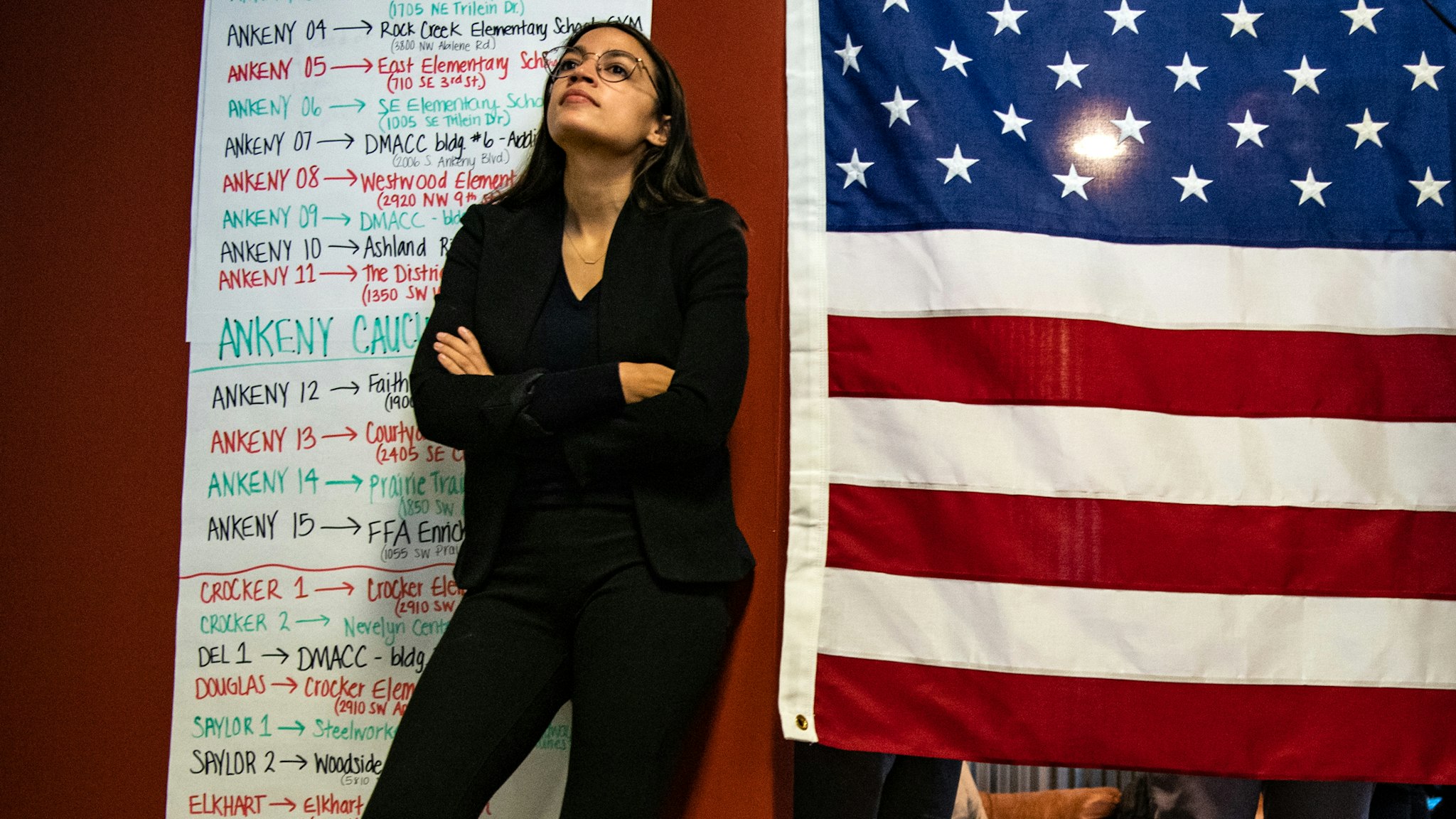 ANKENY, IOWA - JANUARY 26: Rep. Alexandria Ocasio-Cortez, D-N.Y. listens as Sen. Bernie Sanders, I-Vt., 2020 Democratic Presidential Candidate, speak to volunteers and supporters at Ankeny Field Office during a campaign stop on Sunday, January 26, 2020 in Ankeny, Iowa.