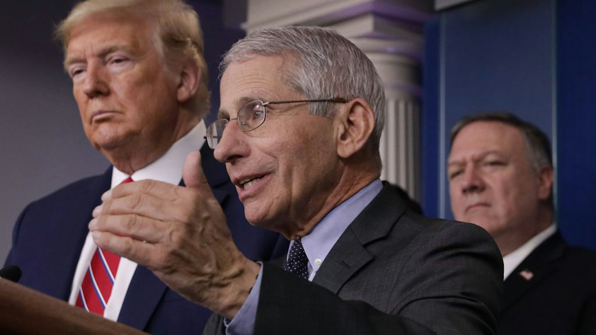 Dr. Anthony Fauci (C) director of the National Institute of Allergy and Infectious Diseases speaks while U.S. President Donald Trump (L) and Secretary of State Mike Pompeo (R) listen during a briefing on the latest development of the coronavirus outbreak in the U.S. in the James Brady Press Briefing Room at the White House March 20, 2020 in Washington, DC. With deaths caused by the coronavirus rising and foreseeable economic turmoil, the Senate is working on legislation for a $1 trillion aid package to deal with the COVID-19 pandemic. President Trump announced that¬†tax day will be delayed from April 15 to July 15. (Photo by Alex Wong/Getty Images)