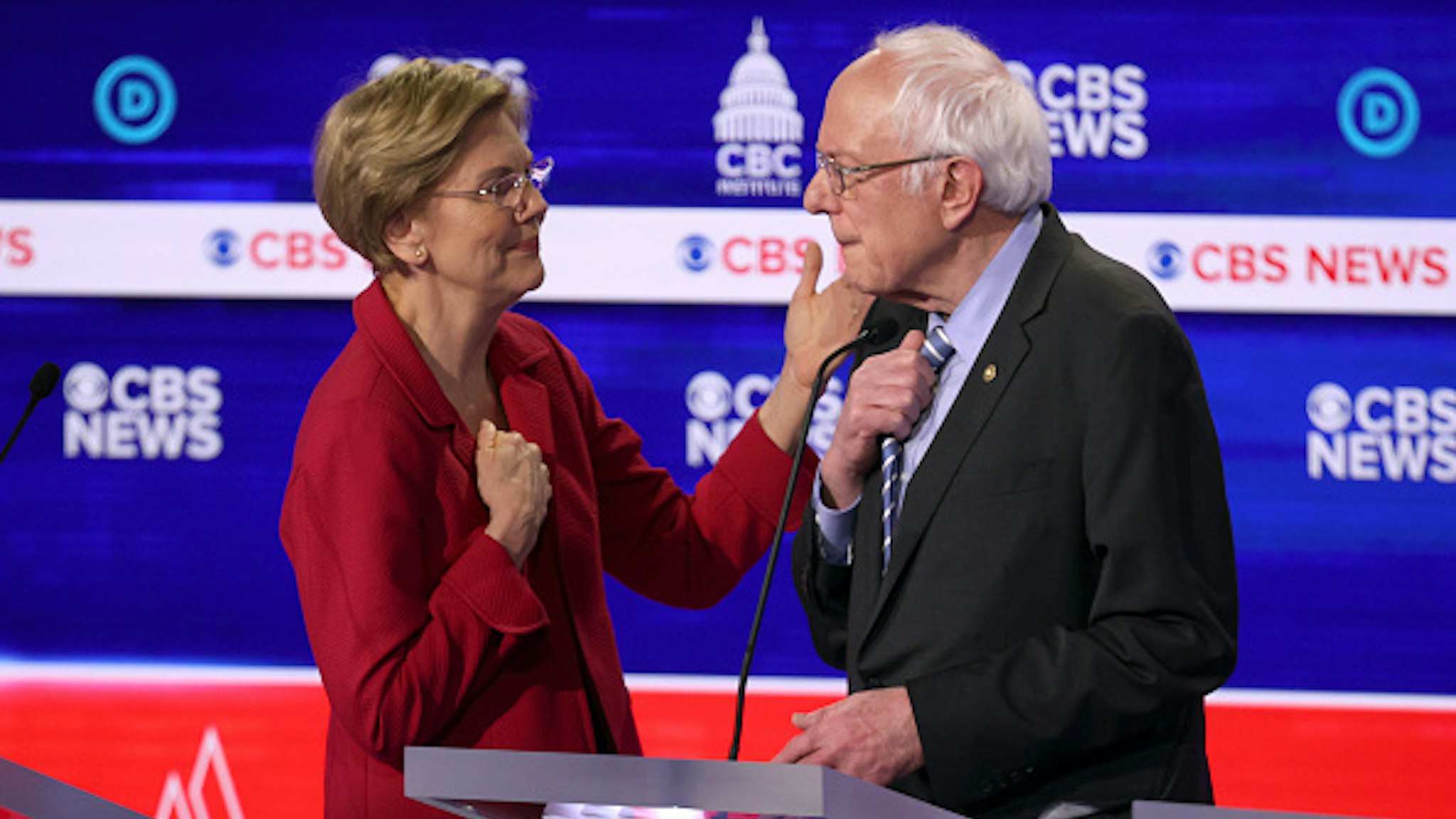 CHARLESTON, SOUTH CAROLINA - FEBRUARY 25: Democratic presidential candidates Sen. Elizabeth Warren (D-MA) (L) and Sen. Bernie Sanders (I-VT) interact during a break at the Democratic presidential primary debate at the Charleston Gaillard Center on February 25, 2020 in Charleston, South Carolina. Seven candidates qualified for the debate, hosted by CBS News and Congressional Black Caucus Institute, ahead of South Carolina’s primary in four days.