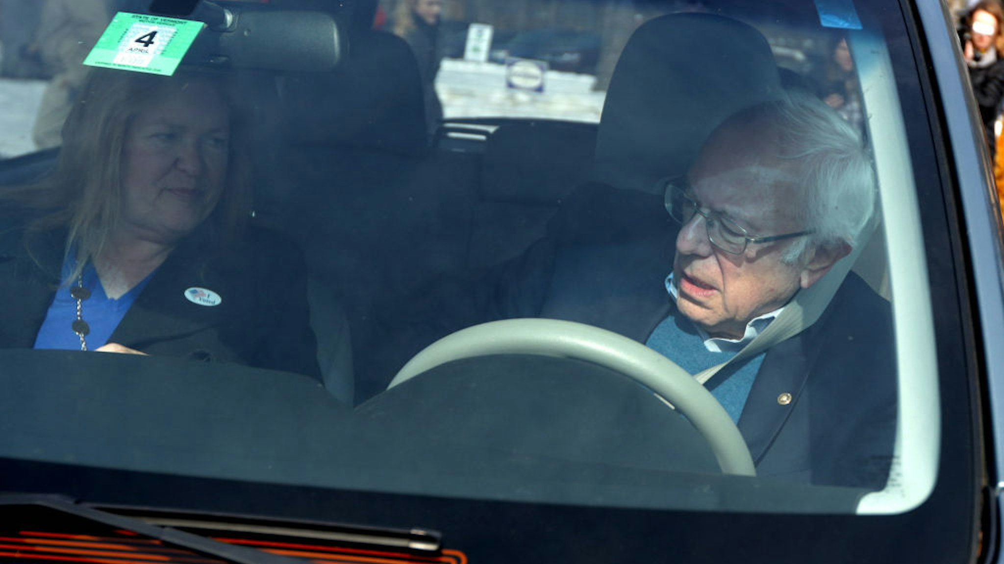 Democratic presidential candidate Sen. Bernie Sanders (I-VT) fastens his seat belt in his vehicle as his wife Jane O'Meara Sanders looks on after they casted their votes at a polling place at Robert Miller Community Center March 3, 2020 in Burlington, Vermont. 1,357 Democratic delegates are at stake as voters cast their ballots in 14 states and American Samoa on what is known as Super Tuesday. (Photo by Alex Wong/Getty Images)