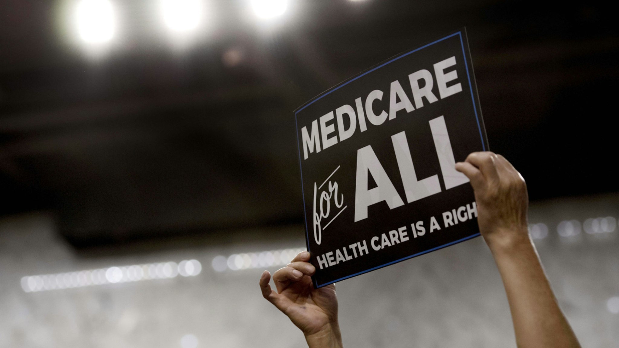 A member of the audience holds up a placard as US Senator Bernie Sanders, Independent from Vermont, discusses Medicare for All legislation on Capitol Hill in Washington, DC, on September 13, 2017.