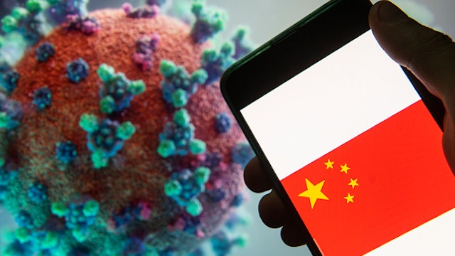 In this photo illustration the People's Republic of China flag logo seen displayed on a smartphone with a computer model of the COVID-19 coronavirus on the background.
