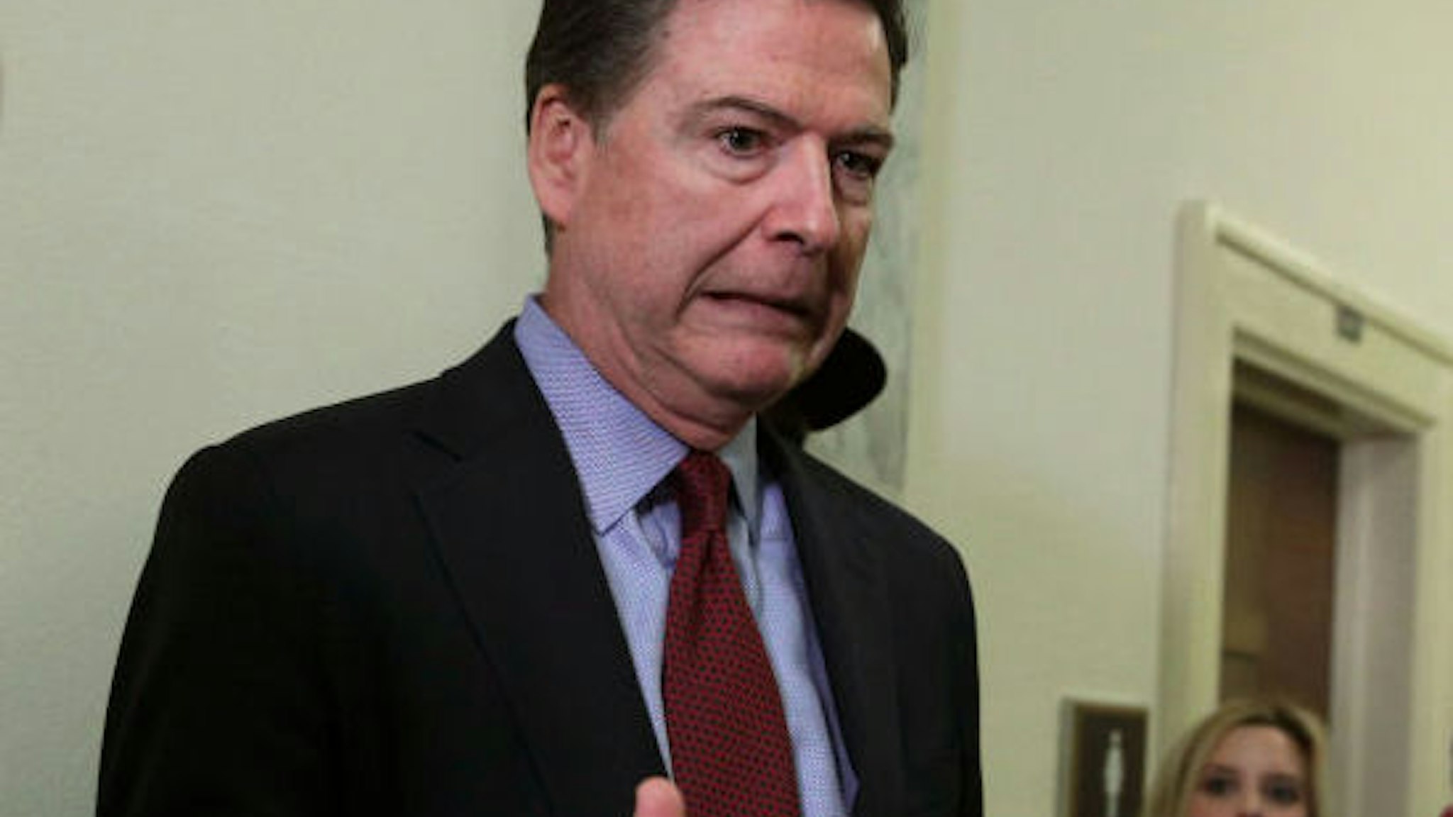 WASHINGTON, DC - DECEMBER 07: Former Federal Bureau of Investigation Director James Comey reacts as he approaches the microphone to speak to members of the media at the Rayburn House Office Building after testifying to the House Judiciary and Oversight and Government Reform committees on Capitol Hill December 07, 2018 in Washington, DC. With less than a month of control of the committees, House Republicans subpoenaed Comey to testify behind closed doors about investigations into Hillary Clinton‚Äôs email server and whether President Trump‚Äôs campaign advisers colluded with the Russian government to steer the outcome of the 2016 presidential election.