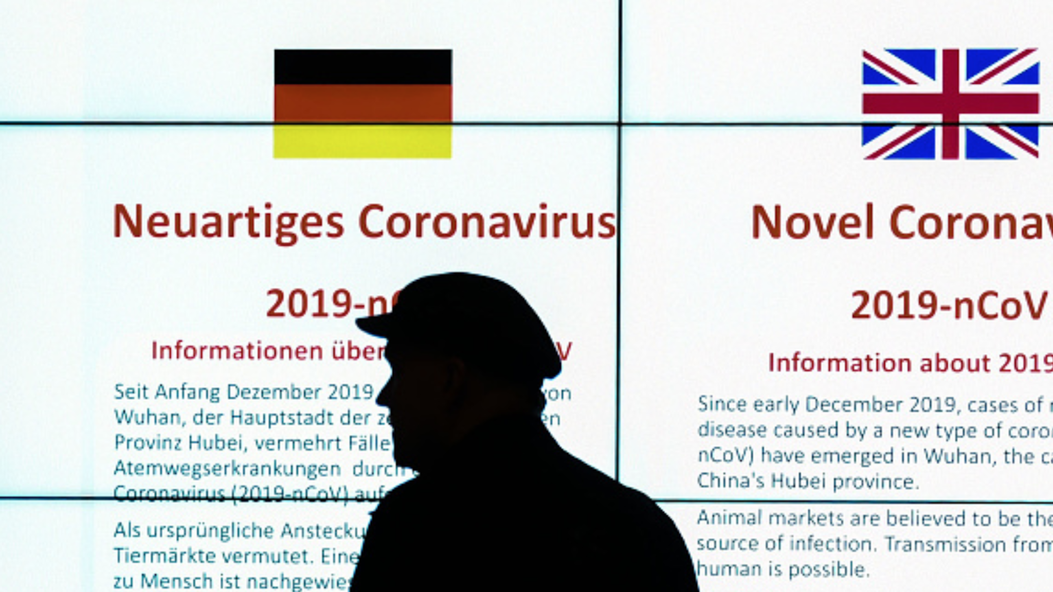 09 March 2020, Berlin: A passenger is standing in front of an information board of the Robert Koch Institute at Berlin's Tegel Airport on the novel corona virus. Photo: Sonja Wurtscheid/dpa