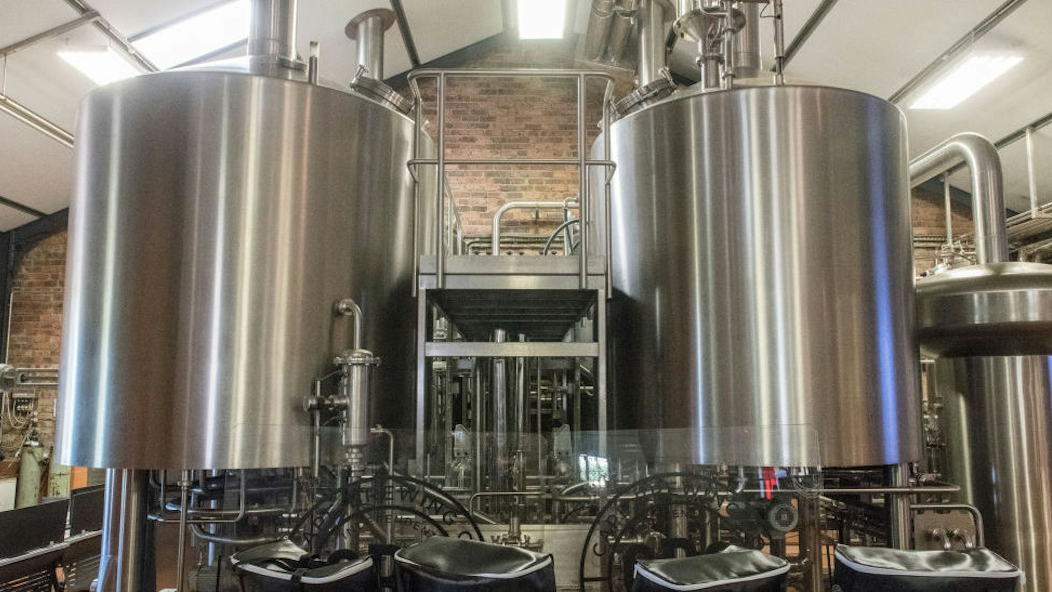 Two metal storage vats containing beer at microbrewery, Cape Town, South Africa. (Photo by: Edwin Remsberg/VW PICS/UIG via Getty Image)