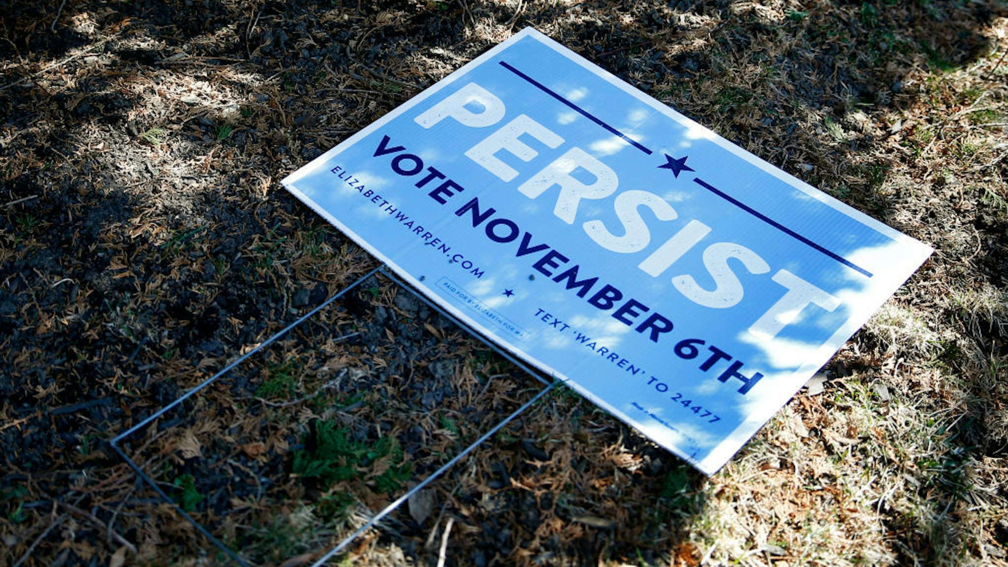 A yard sign for Senator Elizabeth Warren lays on the ground in a yard up the street from the Senator's home as she holds a press conference to announce the end of her Presidential campaign in Cambridge, MA on March 5, 2020. (Photo by Jessica Rinaldi/The Boston Globe via Getty Images)