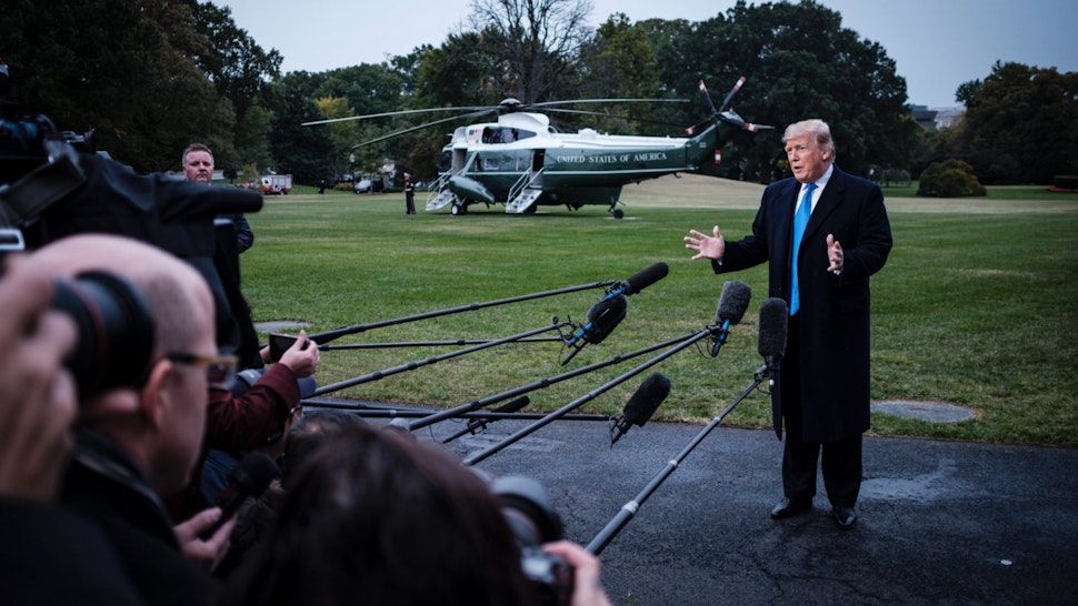 US President Donald Trump speaks to the media as he prepares to board Marine One on the South Lawn of the White House on October 26, 2018 in Washington, DC.