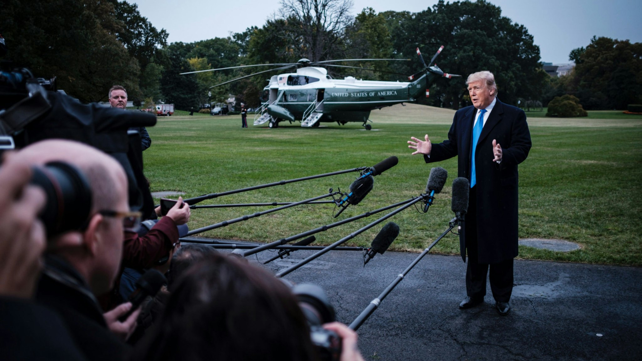 US President Donald Trump speaks to the media as he prepares to board Marine One on the South Lawn of the White House on October 26, 2018 in Washington, DC.