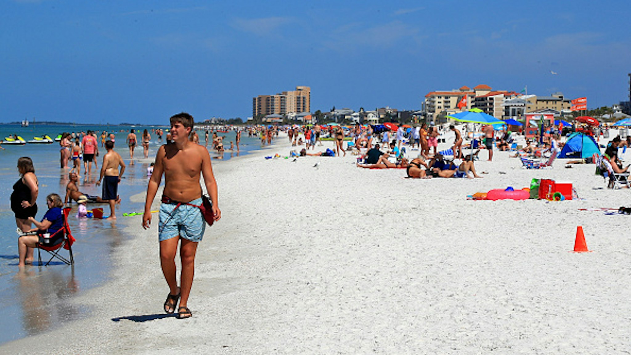 CLEARWATER, FL - MARCH 18: People gather on Clearwater Beach during spring break despite world health officials' warnings to avoid large groups on March 18, 2020 in Clearwater, Florida. The World Health Organization declared COVID-19 a global pandemic on March 11.