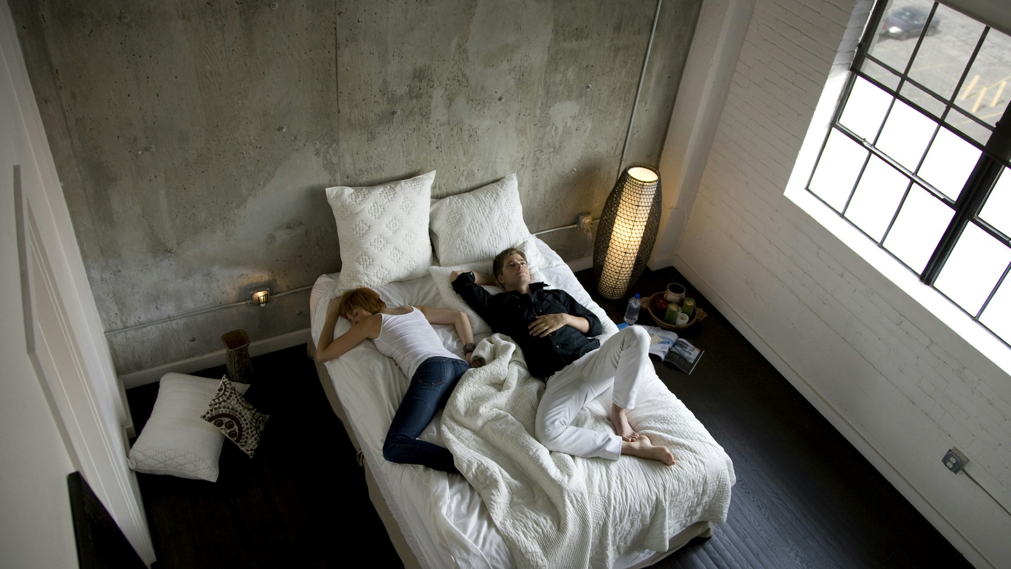 USA, Utah, Salt Lake City, Couple sleeping on bed, elevated view - stock photo