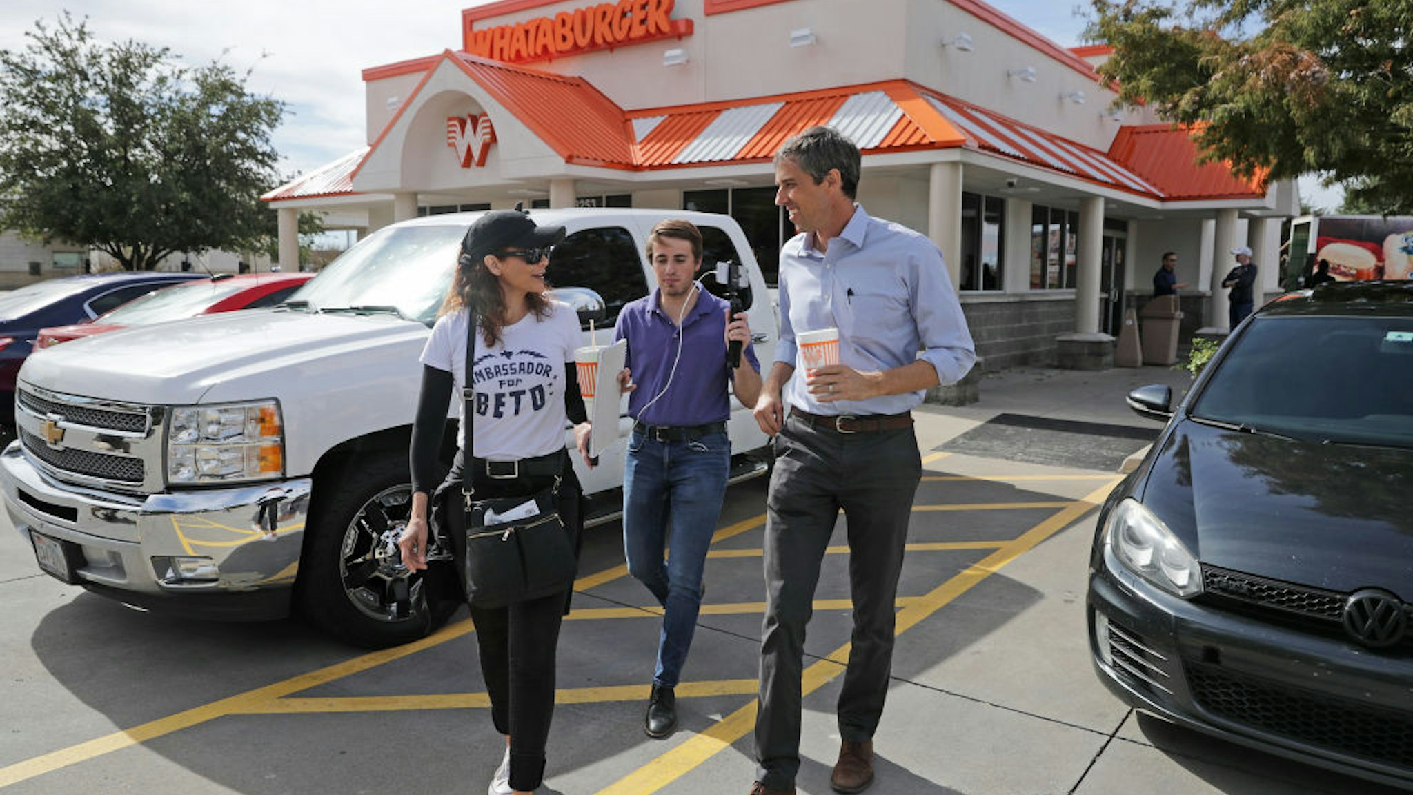 U.S. Senate candidate Rep. Beto O'Rourke (D-TX) (R) talks with his Logistics and Events Manager Cynthia Cano (L) as his Communications Director Chris Evans live streams them leaving lunch at a Whataburger November 3, 2018 in Dallas, Texas.
