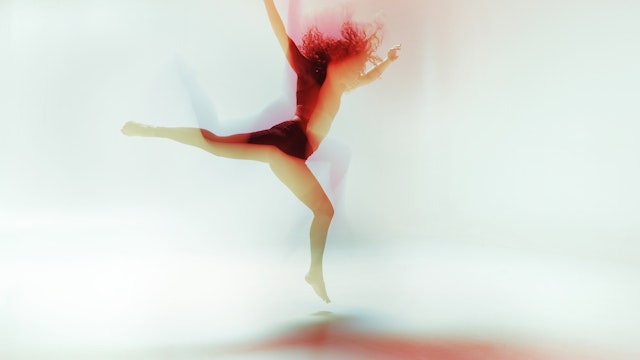 Female dancer moving gracefully and powerful in a bright colorfull room, long time exposure