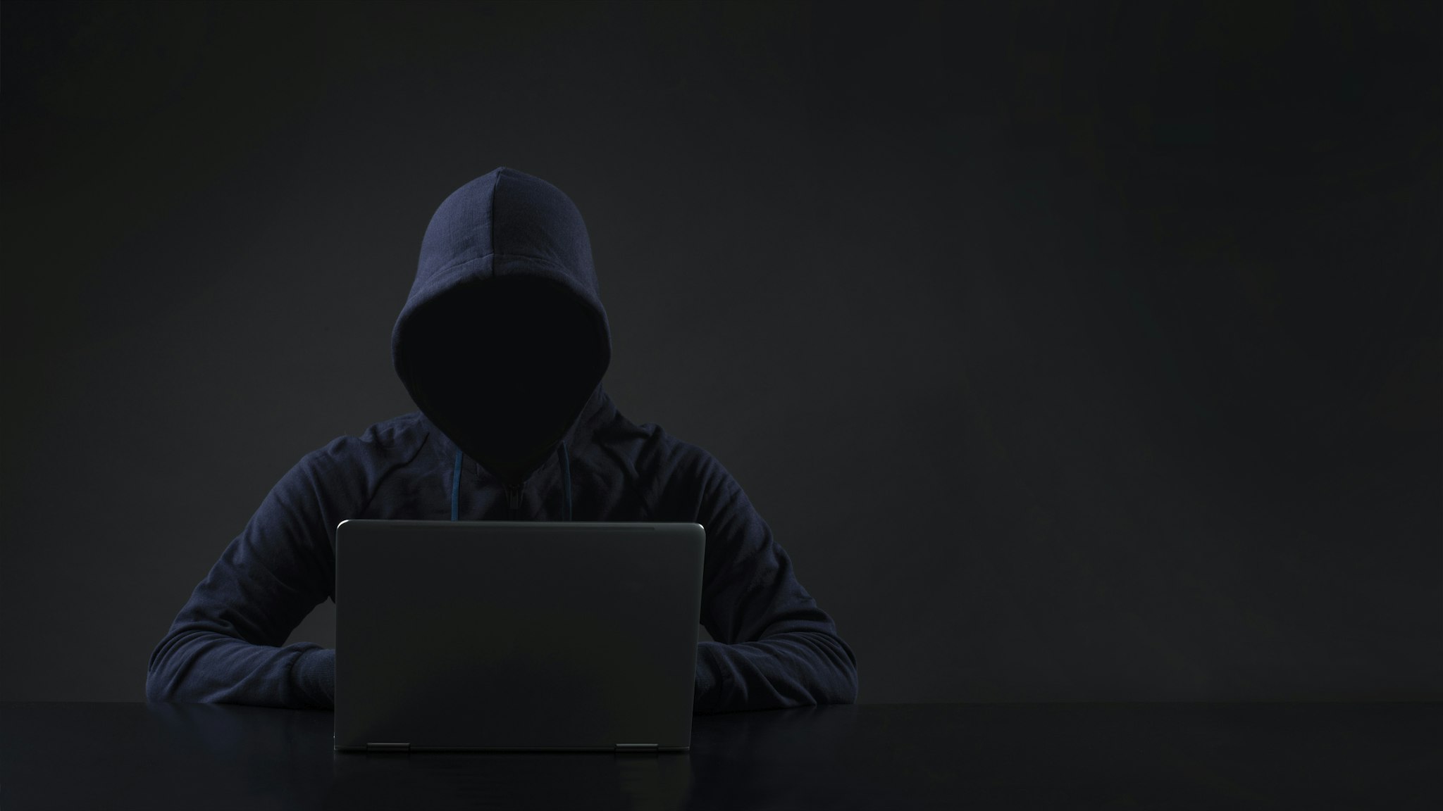 Hacker in front of computer - stock photo