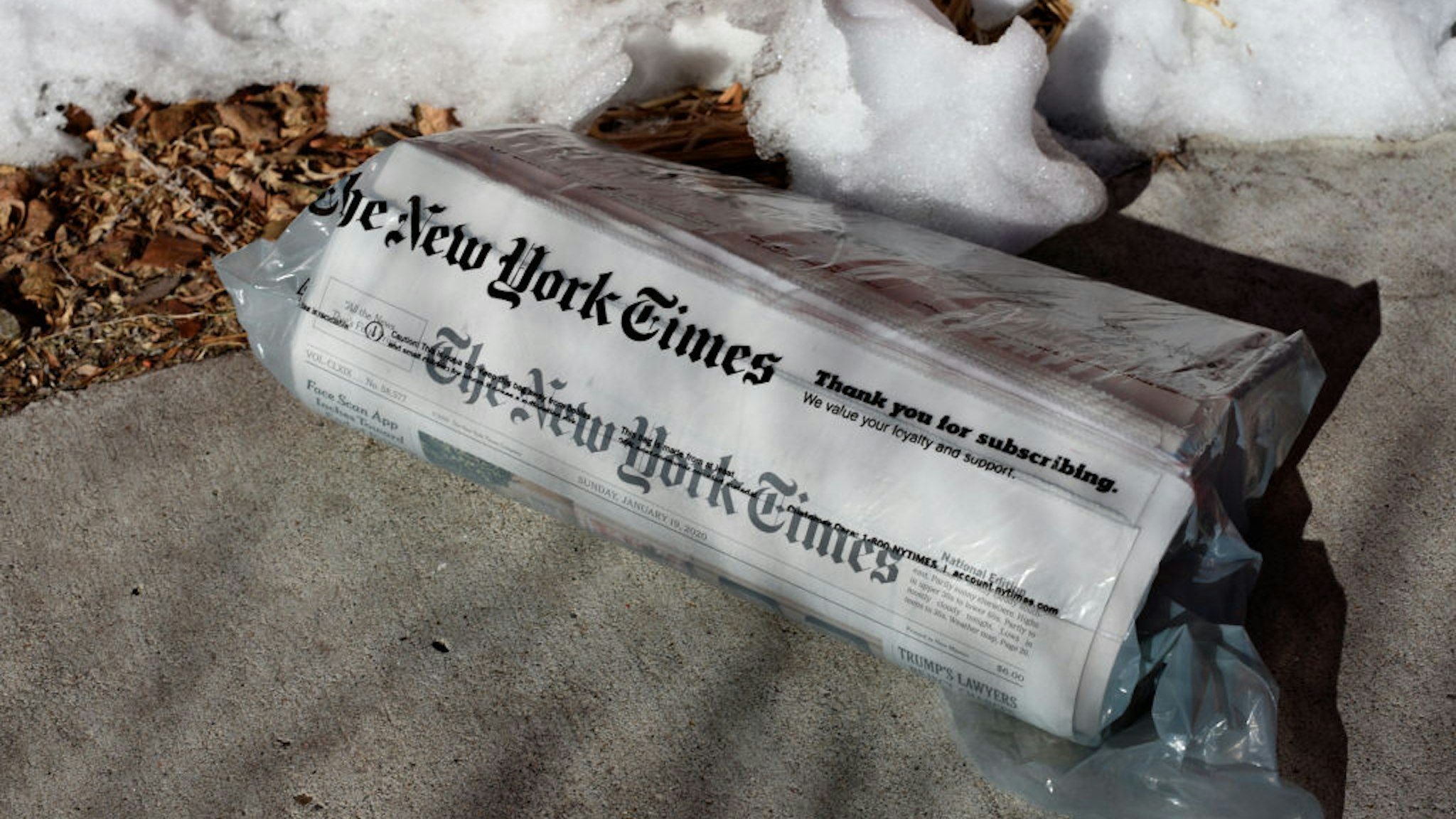 home-delivered copy of The New York Times on a driveway in Santa Fe, New Mexico.