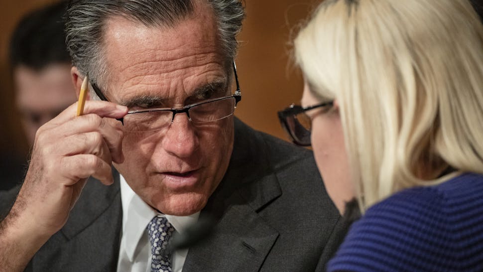 Mitt Romney WASHINGTON, DC - MARCH 05: Sen. Mitt Romney (R-UT) and Sen. Kyrsten Sinema (D-AZ) speak to each other during a Senate Homeland Security Committee hearing on the government's response to the novel coronavirus (COVID-19) outbreak on March 5, 2020 in Washington, DC. COVID-19 has taken hold in the United States and national and local governments are rushing to contain the virus and finding a cure. (Photo by Samuel Corum/Getty Images)