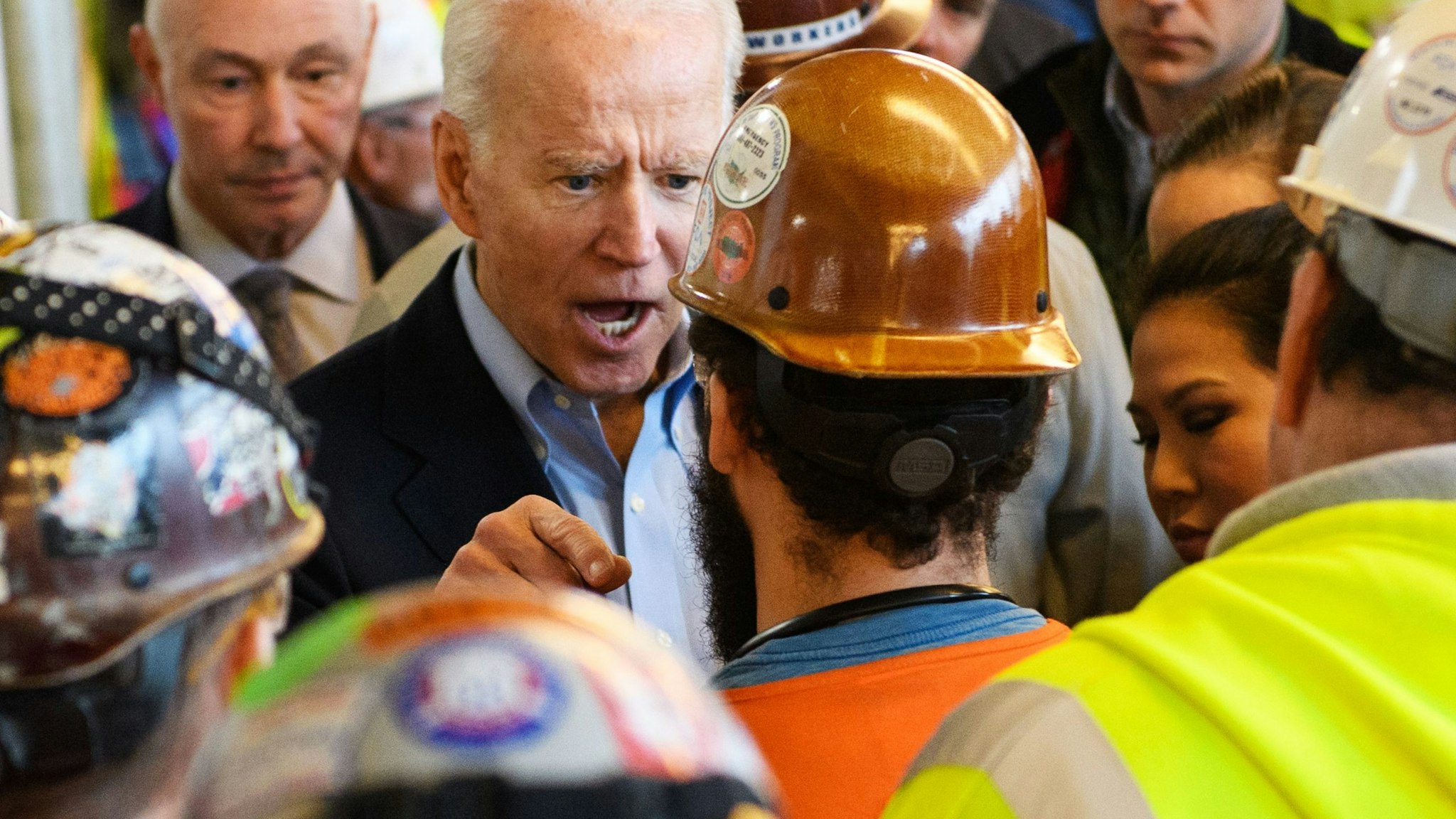 OPSHOT - Democratic presidential candidate Joe Biden has heated exchange meets workers and discusses gun rights as he tours the Fiat Chrysler plant in Detroit, Michigan on March 10, 2020. - Biden opened primary day meeting workers at an under-construction automobile plant in Detroit, where he received cheers but also was confronted by one worker. In an exchange avidly shared online by Trump supporters, the worker, wearing a construction helmet and reflective vest, accused Biden of seeking to weaken the constitutional right to own firearms. "You're full of shit," Biden shot back. "I support the Second Amendment." When the worker pressed the issue, Biden, visibly agitated and with a raised voice, said "I'm not taking your gun away," adding, "Gimme a break, man." (Photo by MANDEL NGAN / AFP) (Photo by MANDEL NGAN/AFP via Getty Images)
