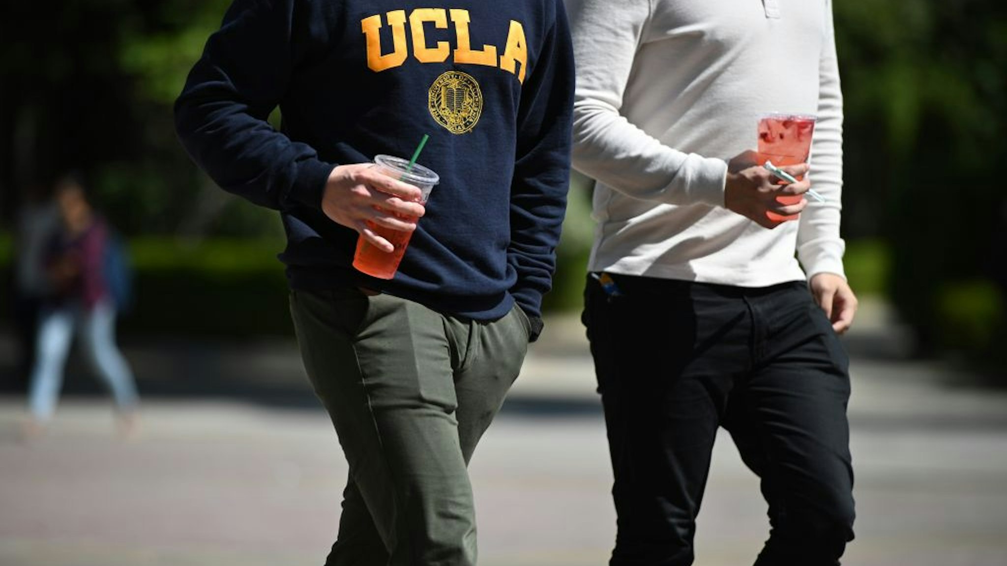 Students walk on the campus of University of California at Los Angeles (UCLA) in Los Angeles, California on March 11, 2020.