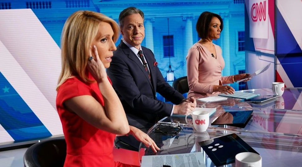 CNN news anchor Jake Tapper (C), flanked by Univision's news anchor Ilia Calderón (R), watches as co-anchor Dana Bash adjusts her ear piece before the start of the 11th Democratic Party 2020 presidential debate with former Vice-President Joe Biden and Vermont Senator Bernie Sanders in a CNN Washington Bureau studio in Washington, DC on March 15, 2020.