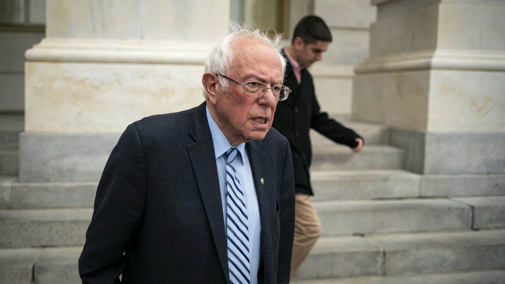 Senator Bernie Sanders, an Independent from Vermont and 2020 presidential candidate, exits the U.S. Capitol after a vote in Washington, D.C., U.S., on Wednesday, March 18, 2020. The Senate cleared the second major bill responding to the coronavirus pandemic, with lawmakers rushing to follow up with an additional economic rescue package that President Donald Trump's administration estimates will cost $1.3 trillion. Photographer: Al Drago/Bloomberg via Getty Images