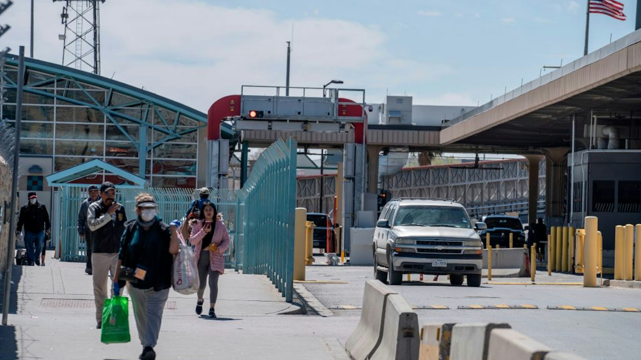 Residents exit US Customs and Border Protection at the Paso del Norte International Bridge during a shut-down of non-essential travel to control the corona virus, COVID-19, outbreak in El Paso, Texas on March 21, 2020.