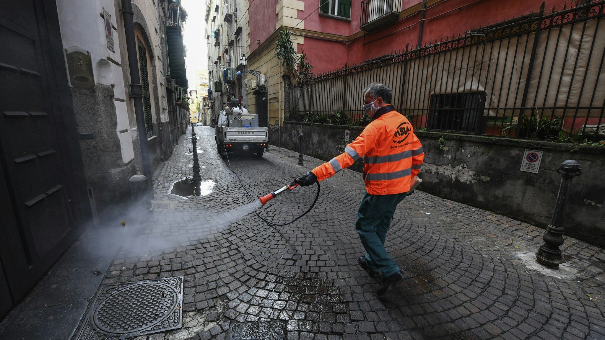 APLES, CAMPANIA, ITALY - 2020/03/31: Sanitary workers disinfect the streets of Naples city to counter the danger of a coronavirus infection (COVID 19). (Photo by Salvatore Laporta/KONTROLAB/LightRocket via Getty Images)