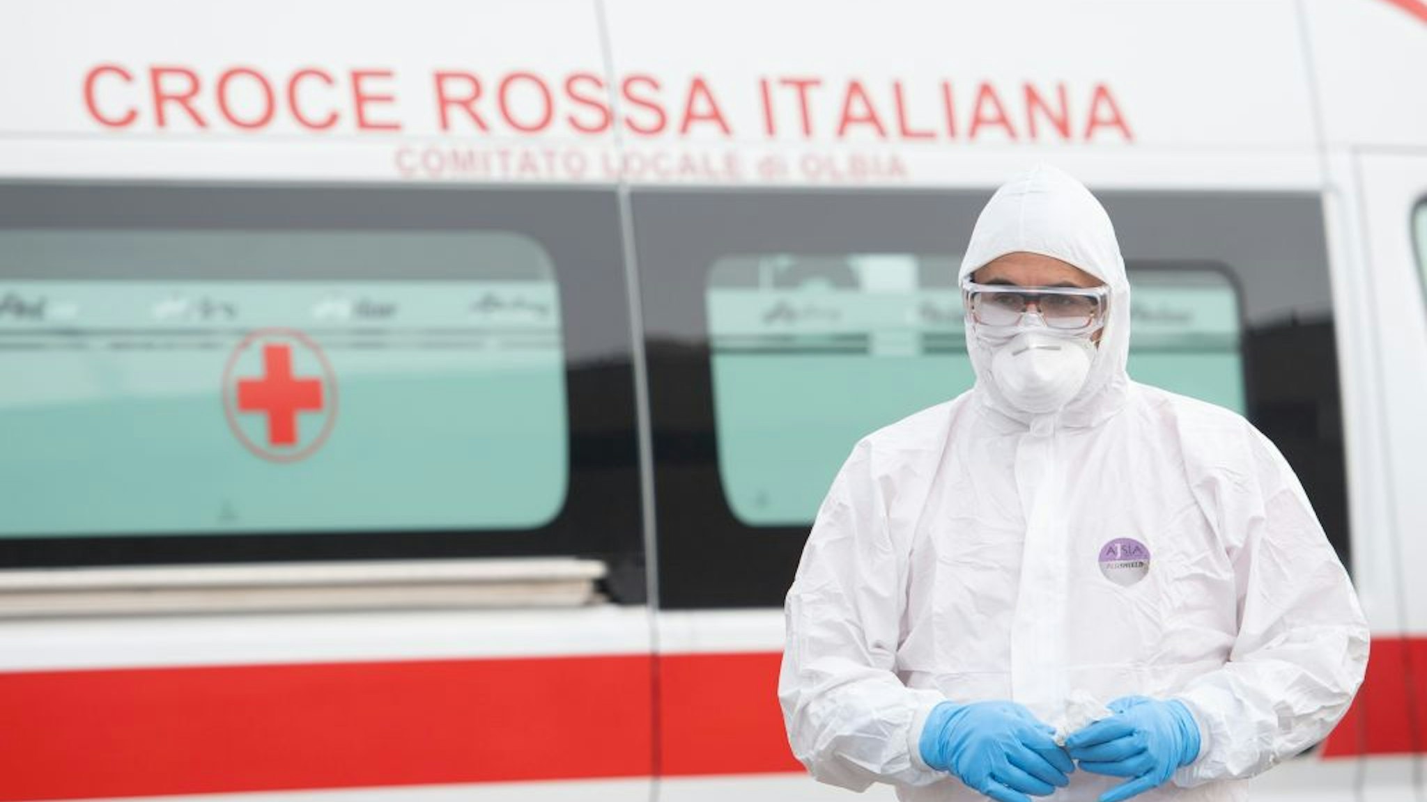 A volunteer wears the protections imposed by the Italian government against coronavirus on March 14, 2020 in Olbia, Italy.
