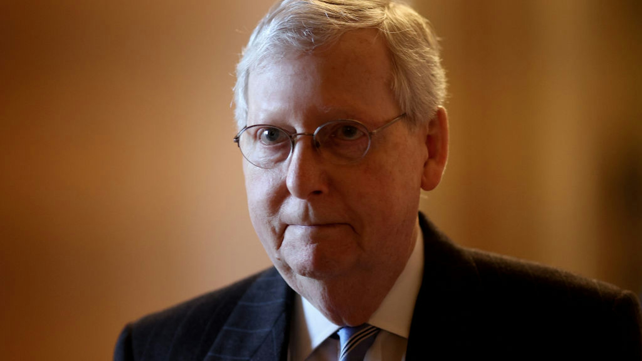 U.S. Senate Majority Leader Mitch McConnell (L) (R-KY) walks to his office while arriving at the U.S. Capitol on March 18, 2020 in Washington, DC.