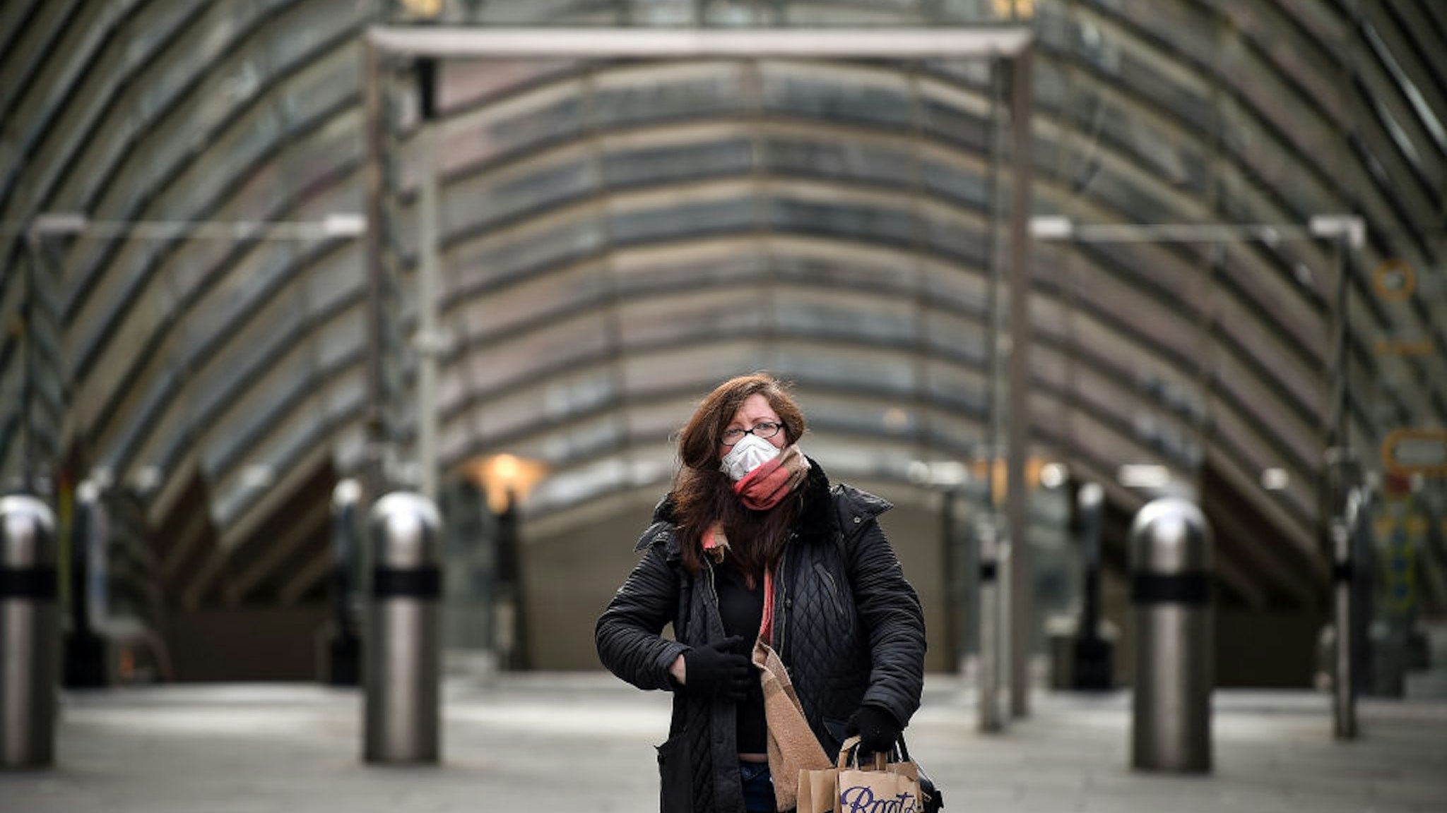 A woman wears a mask outside St Enoch subway station on March 21, 2020 in Glasgow, Scotland. Coronavirus (COVID-19) has spread to at least 182 countries, claiming over 10,000 lives and infecting more than 250,000 people.