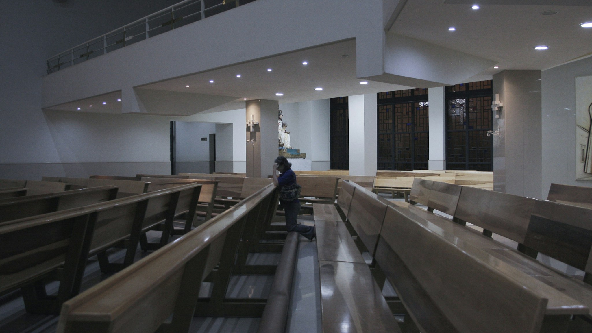 GUADALAJARA, MEXICO - MARCH 27: A woman prays in a empty church on March 27, 2020 in Guadalajara City, Mexico. While most countries and major cities have ordered a lockdown to halt COVID-19 spread, Mexican president Lopez Obrador has not called for national quarantine yet. His critics argue he downplays on coronavirus threat as he seek to protect the economy. In Guadalajara, measures to avoid the spread of the COVID-19 have been taken, schools of all levels are closed since March 16, business around the city must shut down and many tests will be taken in people suspected to be infected. 81 cases have been confirmed in Mexican State of Jalisco. (Photo by Leonardo Alvarez Hernandez/Getty Images)