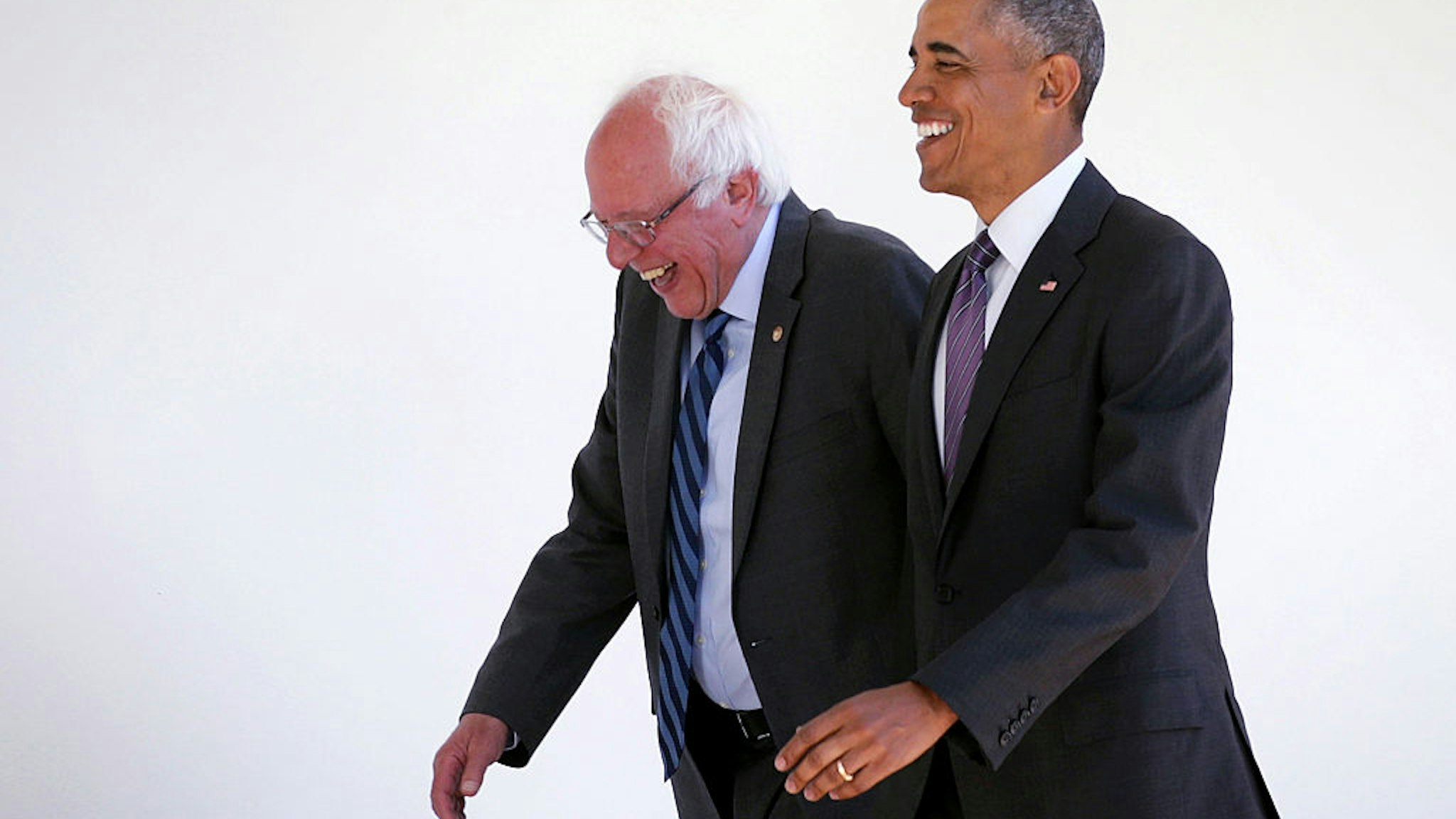 Democratic presidential candidate Sen. Bernie Sanders (D-VT) (L) walks with President Barack Obama (R) through the Colonnade as he arrives at the White House for an Oval Office meeting June 9, 2016 in Washington, DC.