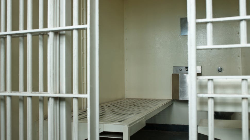 Open door to prison cell jail cell