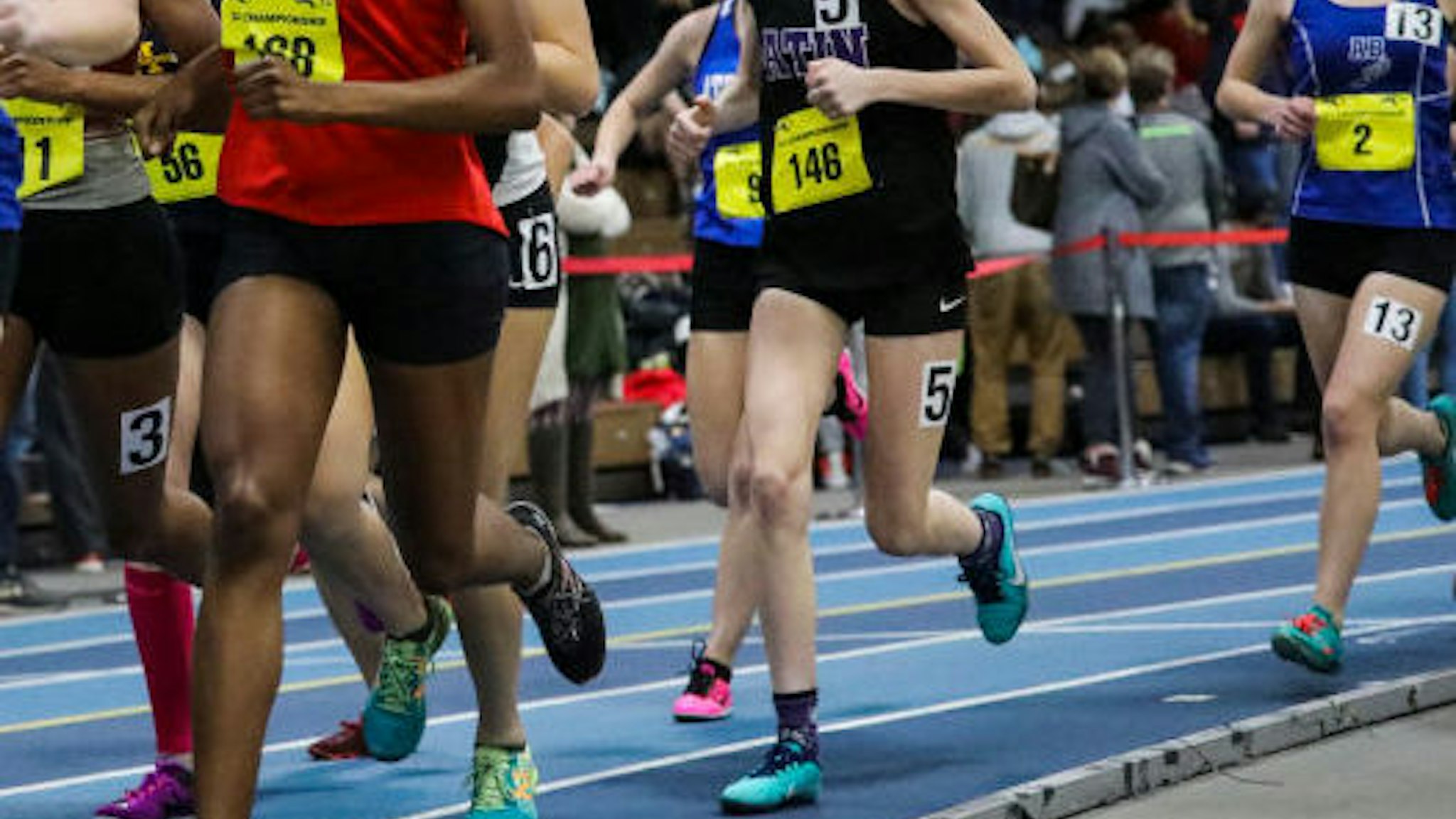 Girls compete in a high school track event.