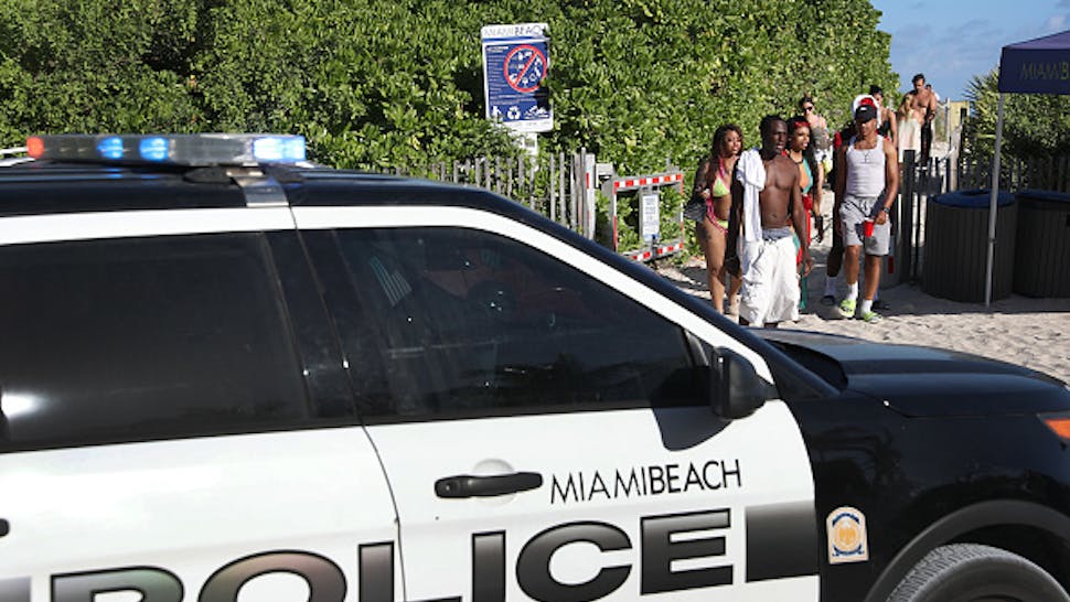 Miami Beach Reacts To Coronavirus By Shutting Down Beaches To Limit Spring Break Gatherings MIAMI BEACH, FLORIDA - MARCH 15: Beach goers walk past a police car as they exit from South Beach as the city closes it after 5pm in an effort to prevent the spread of the coronavirus on March 15, 2020 in Miami Beach, Florida. Miami Beach city officials temporarily closed the beach popular with college spring breakers and asked them to refrain from large gatherings where COVID-19 could spread.