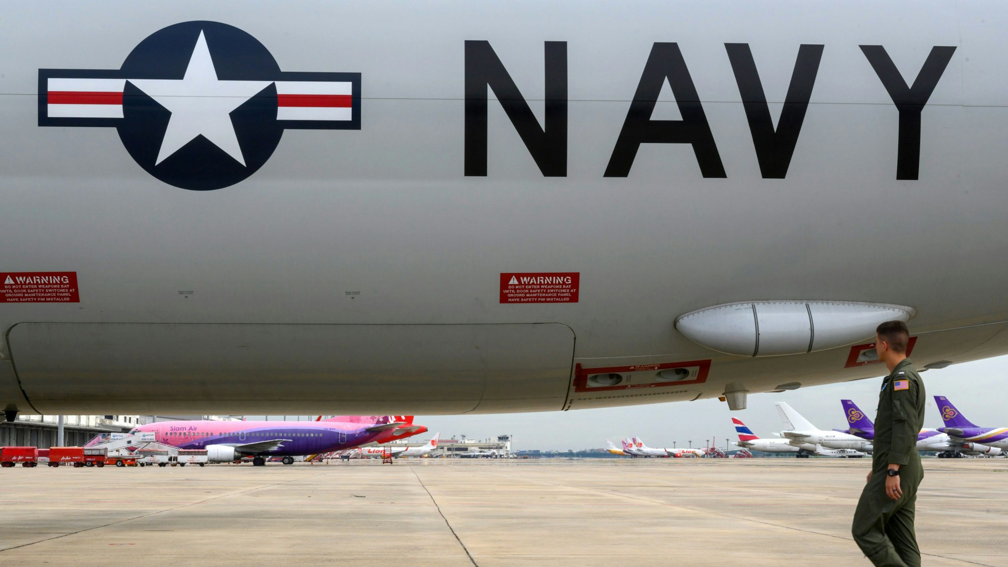 A US Navy aircrew member does a pre-flight walkaround for the P-8A Poseidon maritime patrol and reconnaissance aircraft during the US and Association of Southeast Asian Nations (ASEAN) maritime exercise in the Gulf of Thailand on September 5, 2019.