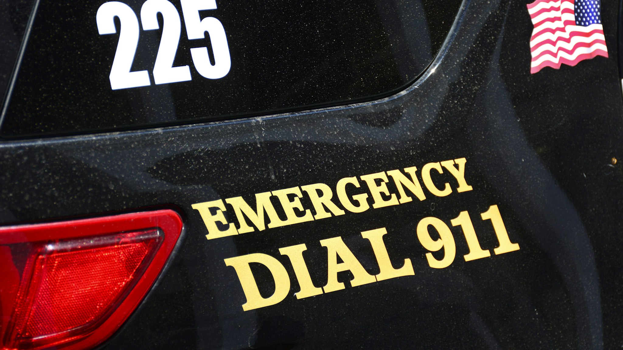 SANTA FE, NM - JULY 27, 2017: A Santa Fe, New Mexico, police car is marked with 'Emergency Dial 911' painted on its side.