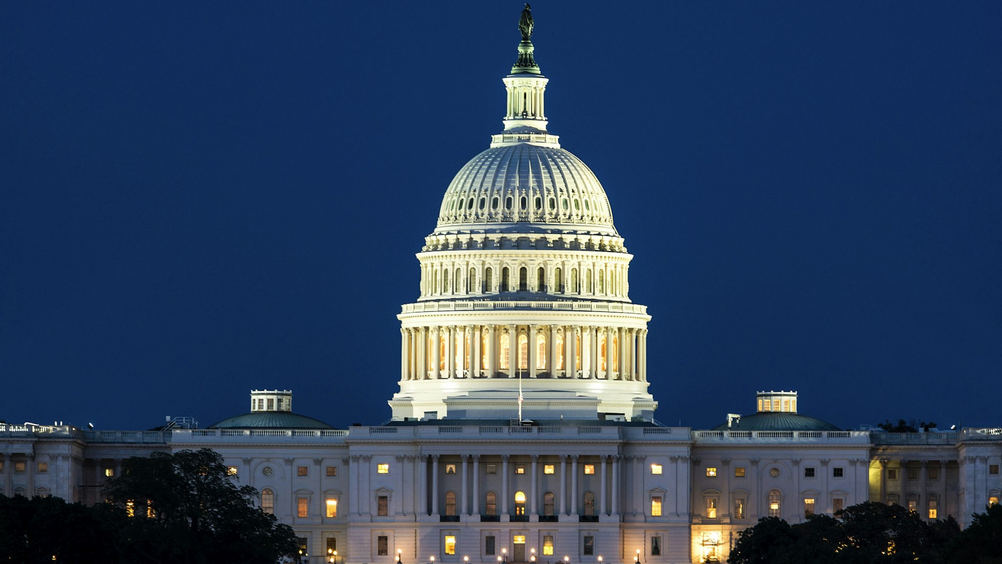 The United States Capitol Building at night.