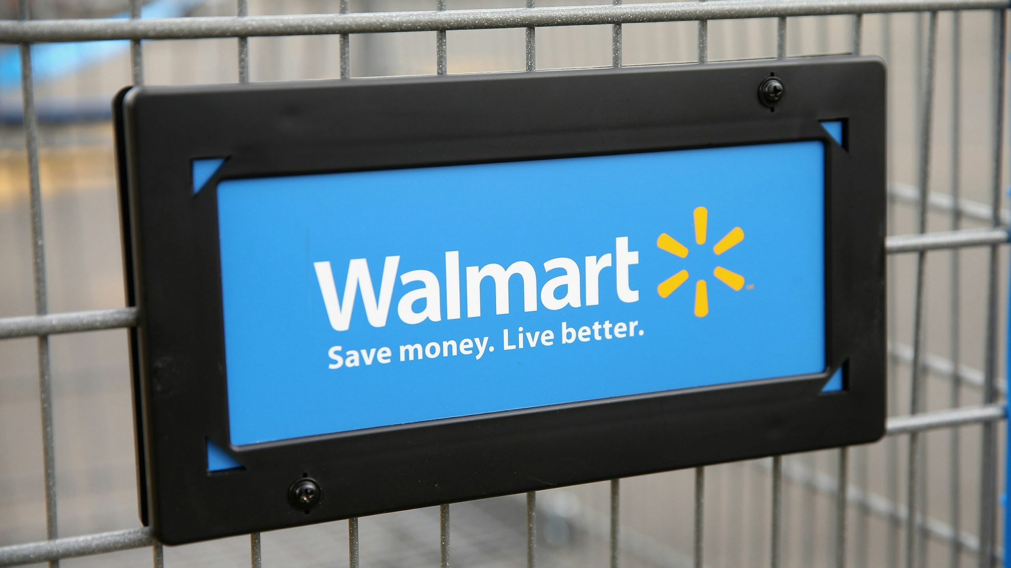 CHICAGO, IL - AUGUST 15: The Walmart logo is displayed on a shopping cart at a Walmart store on August 15, 2013 in Chicago, Illinois. Walmart, the world's largest retailer, reported a surprise decline in second-quarter same-store sales today. The retailer also cut its revenue and profit forecasts for the fiscal year.