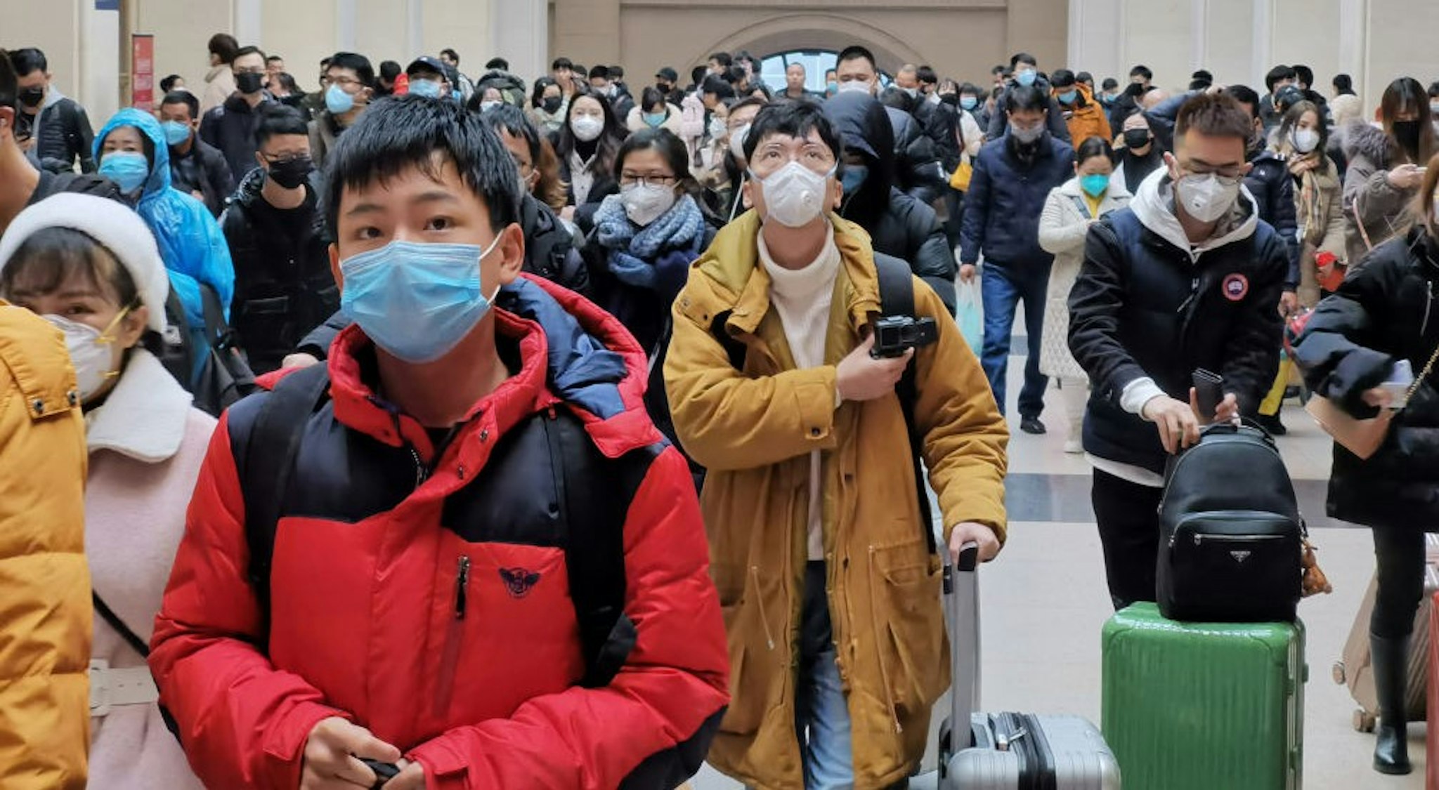WUHAN, CHINA - JANUARY 22: People wear face masks as they wait at Hankou Railway Station on January 22, 2020 in Wuhan, China. A new infectious coronavirus known as "2019-nCoV" was discovered in Wuhan last week. Health officials stepped up efforts to contain the spread of the pneumonia-like disease which medical experts confirmed can be passed from human to human. Cases have been reported in other countries including the United States,Thailand, Japan, Taiwan, and South Korea. It is reported that Wuhan will suspend all public transportation at 10 AM on January 23, 2020.