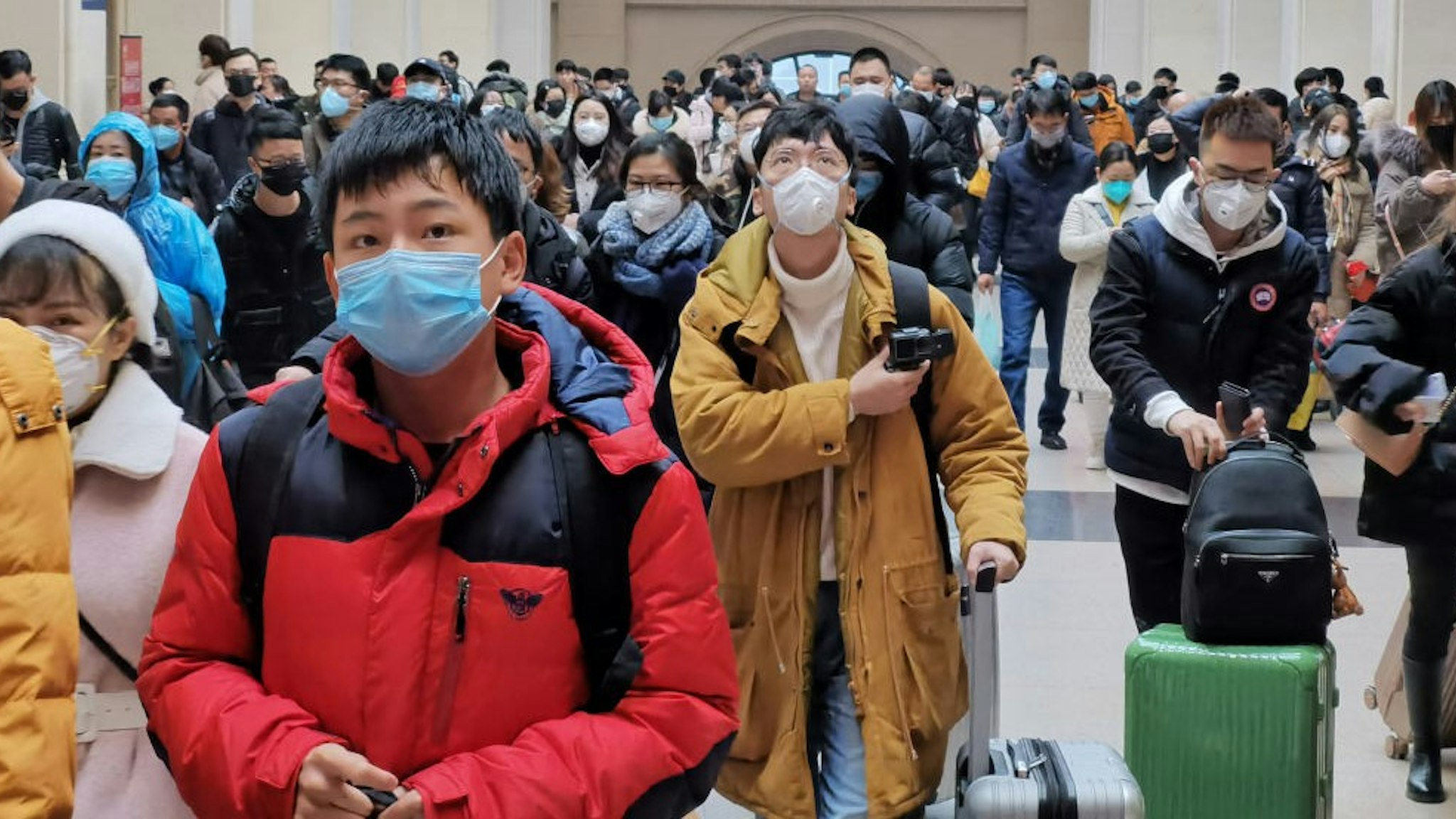 WUHAN, CHINA - JANUARY 22: People wear face masks as they wait at Hankou Railway Station on January 22, 2020 in Wuhan, China. A new infectious coronavirus known as "2019-nCoV" was discovered in Wuhan last week. Health officials stepped up efforts to contain the spread of the pneumonia-like disease which medical experts confirmed can be passed from human to human. Cases have been reported in other countries including the United States,Thailand, Japan, Taiwan, and South Korea. It is reported that Wuhan will suspend all public transportation at 10 AM on January 23, 2020.