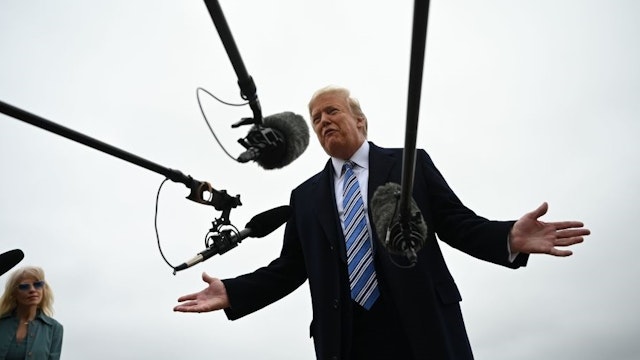 US President Donald Trump speaks to press as he departs the White House in Washington, DC, on March 28, 2020. - Trump travels to Norfolk, Virginia, to attend the departure ceremony for the hospital ship USNS Comfort. The ship sails to New York City to aid in the coronavirus outbreak. (Photo by JIM WATSON / AFP) (Photo by