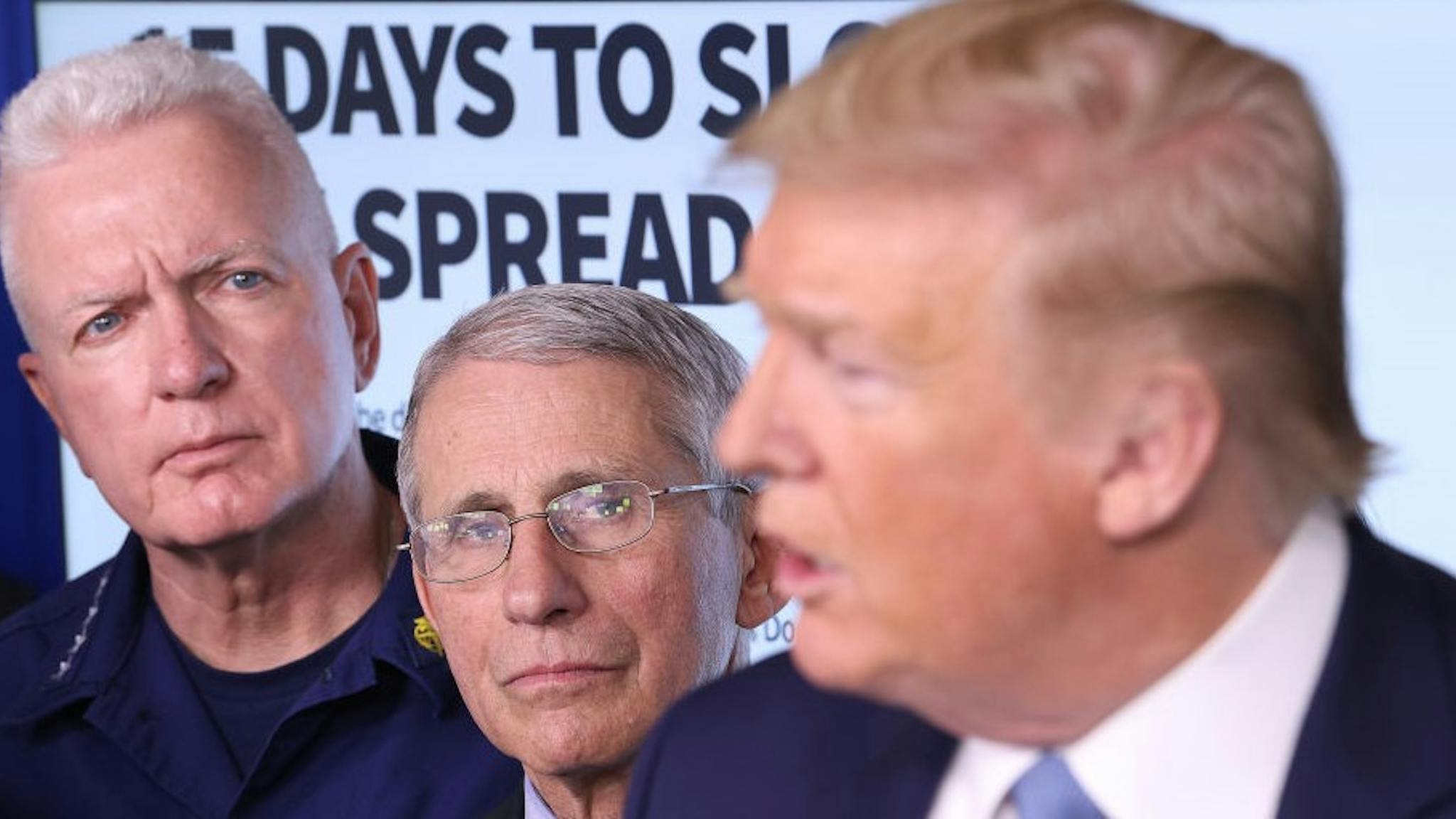 Coronavirus Task Force Briefs Press At White House WASHINGTON, DC - MARCH 16: Dr. Anthony Fauci, (C) director of the National Institute of Allergy and Infectious Diseases listens to U.S. President Donald Trump speak to the media during a press briefing on the Coronavirus, at the White House on March 16, 2020 in Washington, DC. The United States has surpassed 3,000 confirmed cases of the coronavirus, and the death toll climbed to at least 61, with 25 of the deaths associated with the Life Care Center in Kirkland, Washington. (Photo by